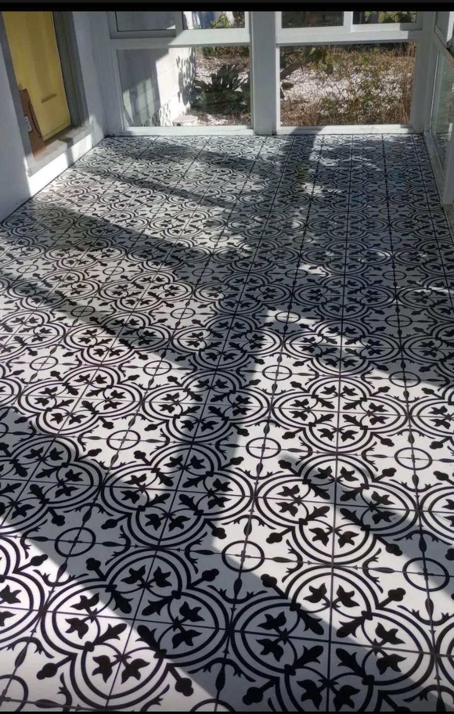 Black and white patterned tile floor laid across a bright room